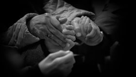 Close-Up Of People Praying By Holding Hands