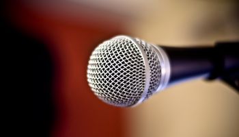 Close up of metal microphone against defocused background