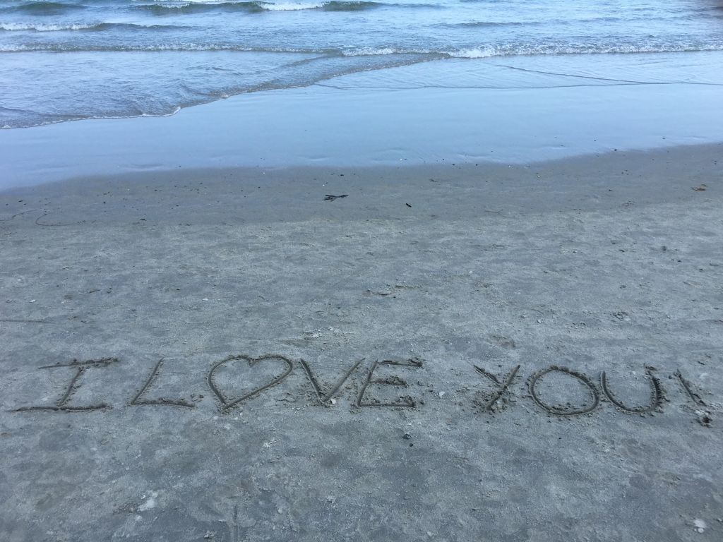 High Angle View Of I Love You Text On Shore At Beach