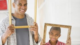 Father and son looking through empty frames