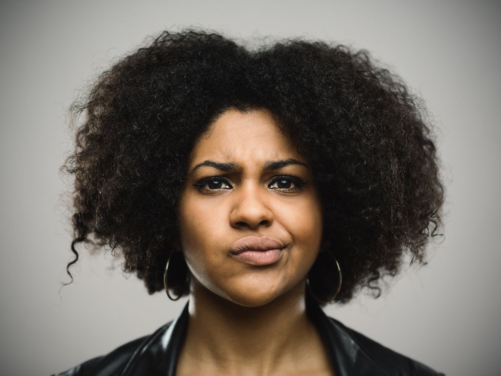 Close-up portrait of displeased young afro american woman