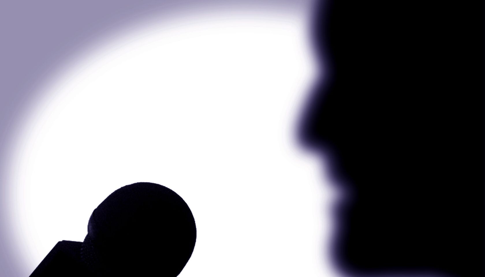A person speaks into a microphone, 30 May 2001. Note: This image has been digit