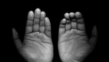 Close-Up Of Hands Against Black Background