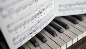 Close up sheet music over piano keys