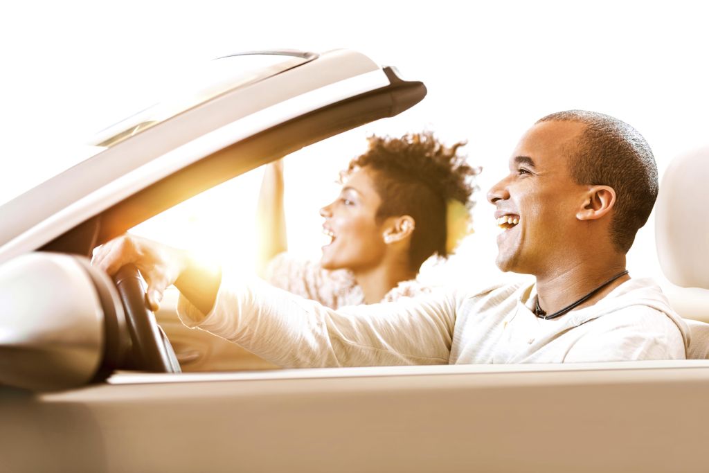 African-American couple in convertible car.