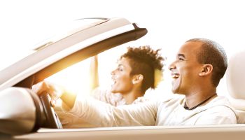 African-American couple in convertible car.
