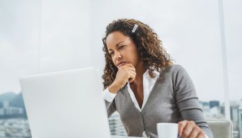 Pensive African American businesswoman using computer at office.