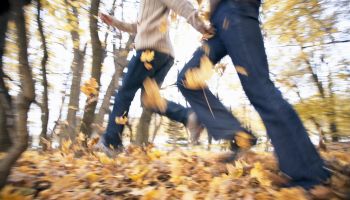 Blurred motion shot of couple running in park