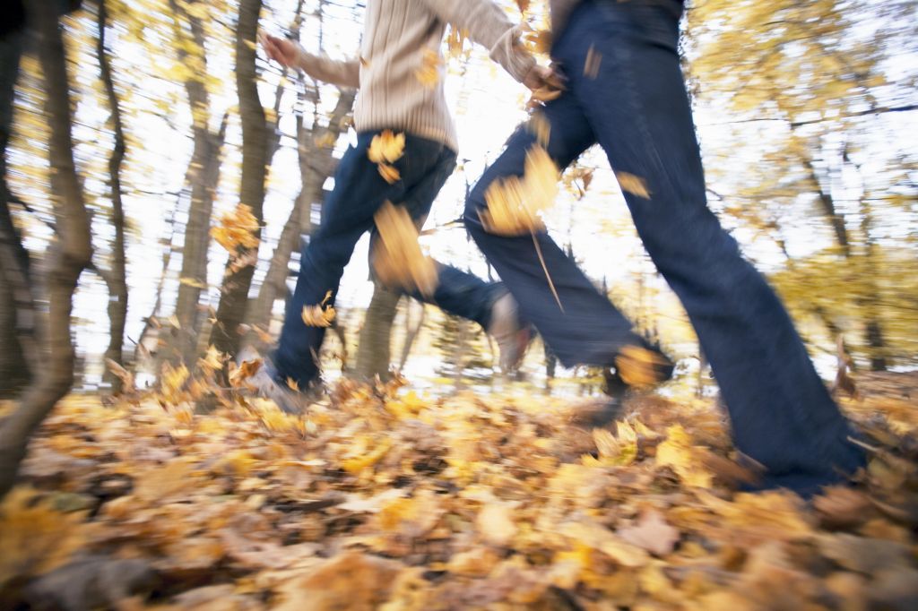 Blurred motion shot of couple running in park