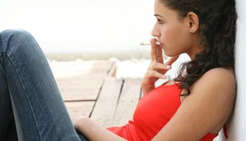 Girl in teenage smoking cigarette in New Delhi, India