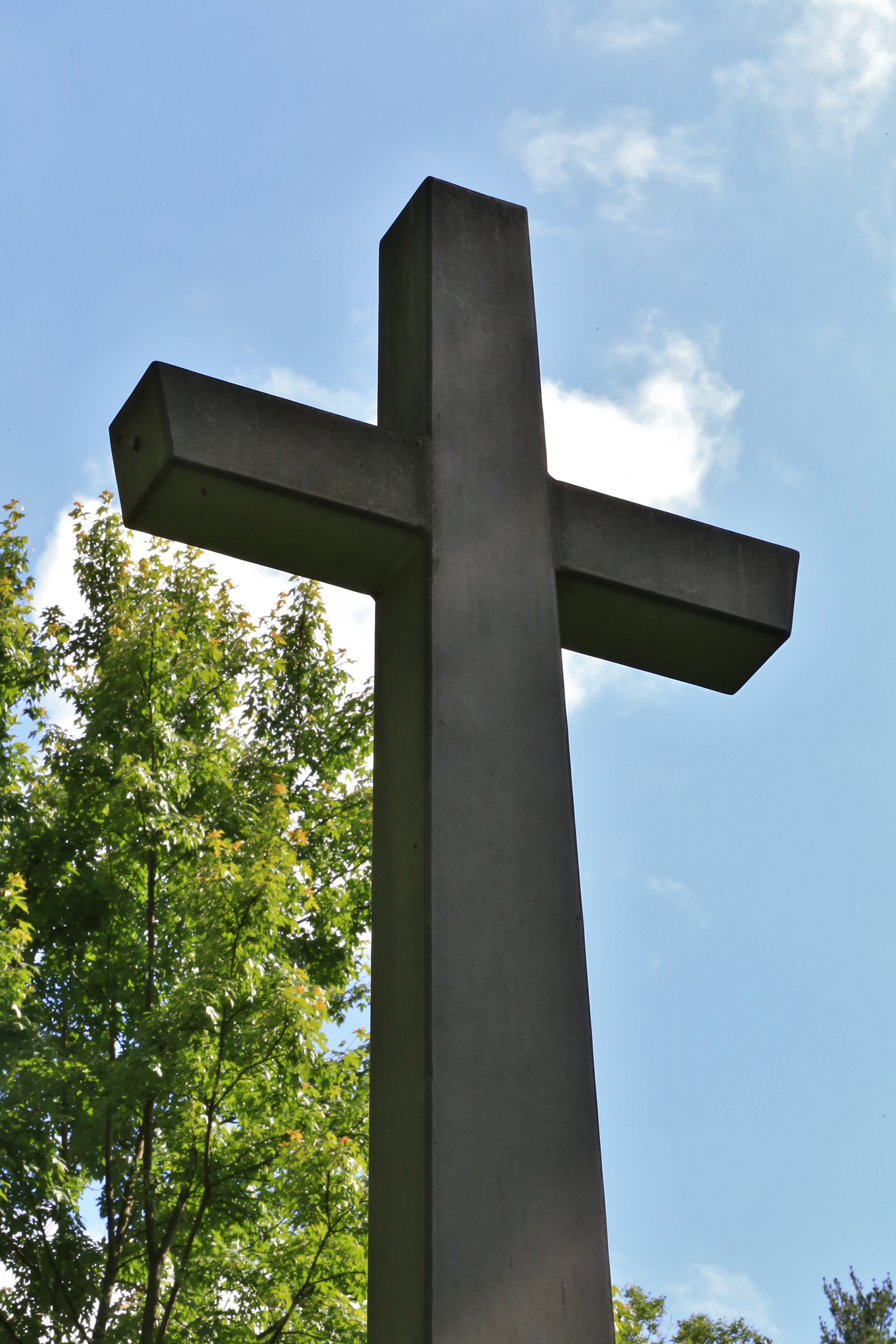 Looking up at an outdoor stone cross