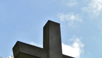 Looking up at an outdoor stone cross