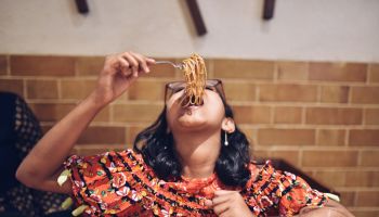 Tweenage girl eating noodles