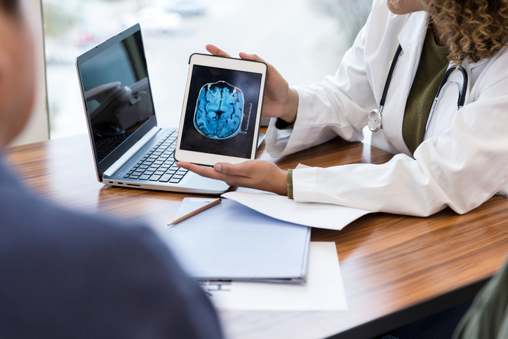 Neurologist reviews patient's brain MRI scan