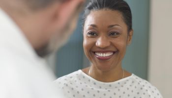Woman patient smiling at doctor