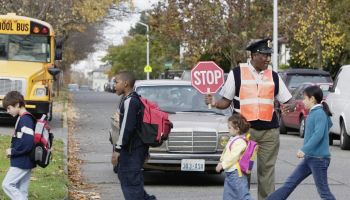 Crossing Guard Helping Kids Cross Safely