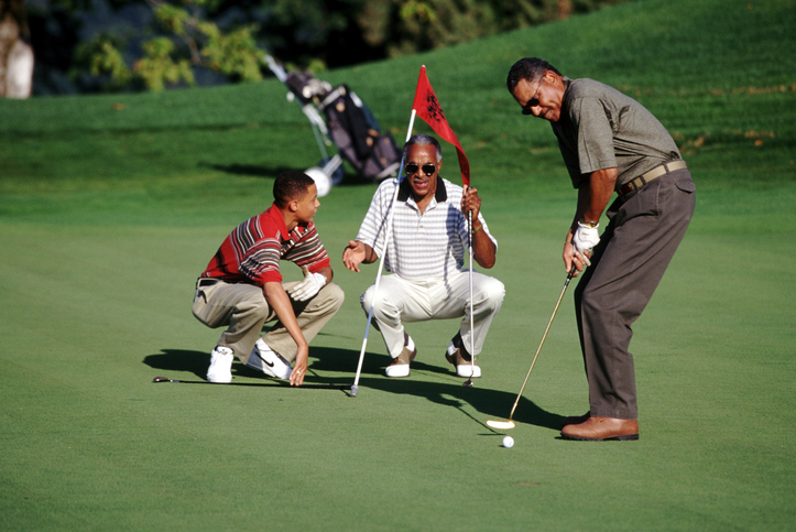 Grandfather Teaching Golf to Grandson