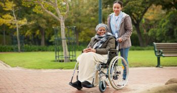Nurse, peace and park with old woman in a wheelchair for retirement, elderly care and physical therapy. Trust, medical and healthcare with african patient and caregiver in nature for rehabilitation