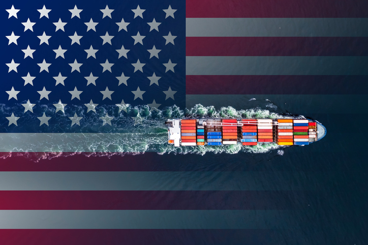 Container ship at sea on the background of the US flag