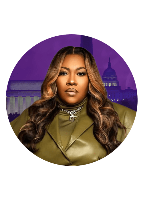 A woman with long, wavy brown hair wearing a green coat and gold necklace, standing in front of the U.S. Capitol building.